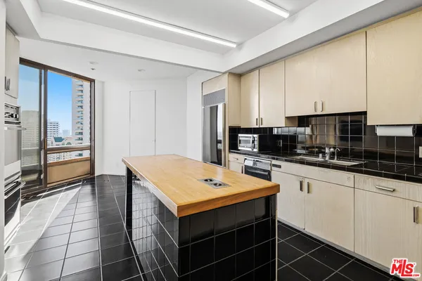 a kitchen with stainless steel appliances a stove top oven and a refrigerator