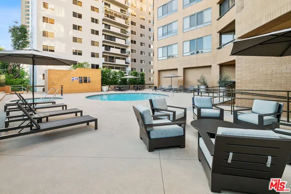 a view of a swimming pool with outdoor seating