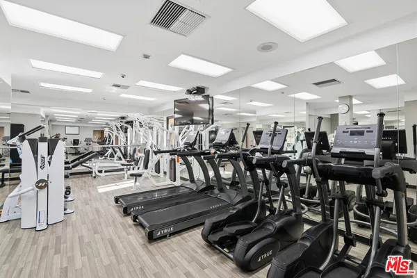 a living room with lots of furniture and gym equipment