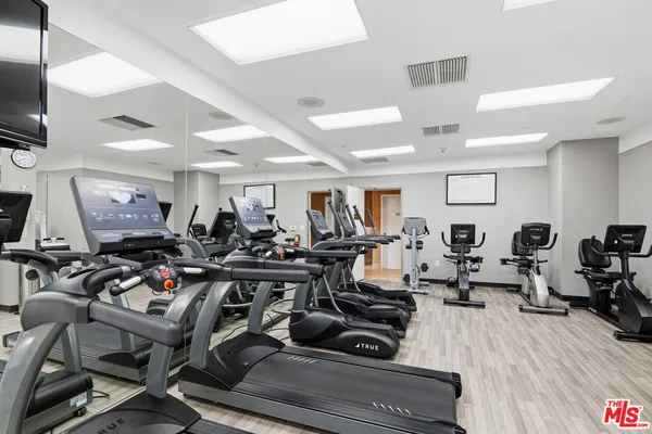 a view of a room with lots of gym equipment