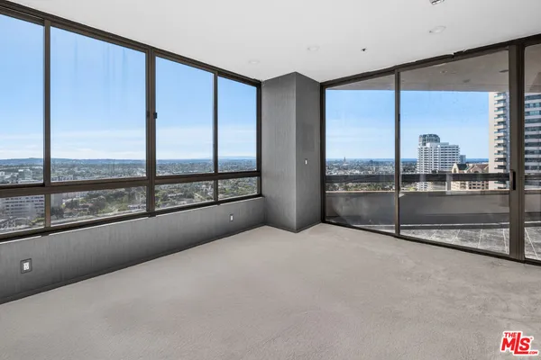 a view of an empty room with a large window