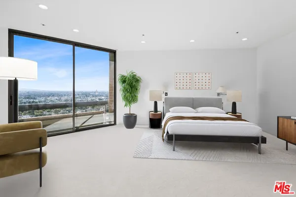 a spacious bedroom with a large bed and a large window