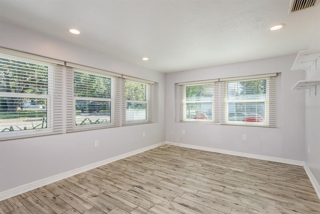 819 10th Street Southwest, Unit A Largo, FL 33770 - Photo 11 of 29 a view of an empty room with wooden floor and a window