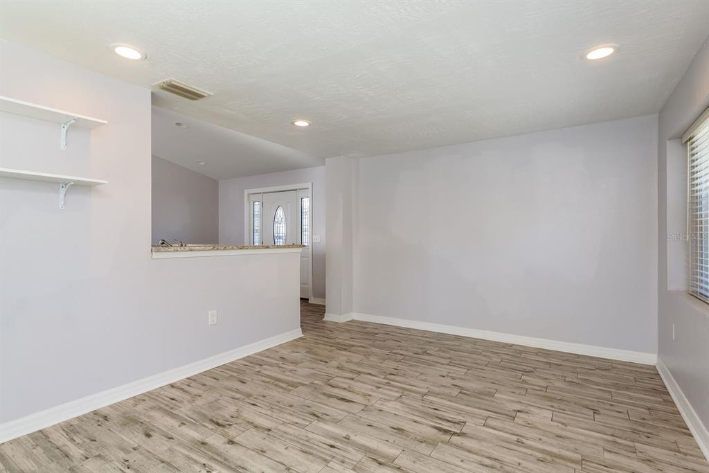 819 10th Street Southwest, Unit A Largo, FL 33770 - Photo 13 of 29 a view of empty room with wooden floor and fan