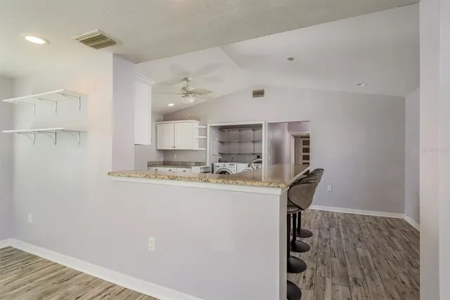 a kitchen with stainless steel appliances granite countertop a refrigerator and a stove top oven