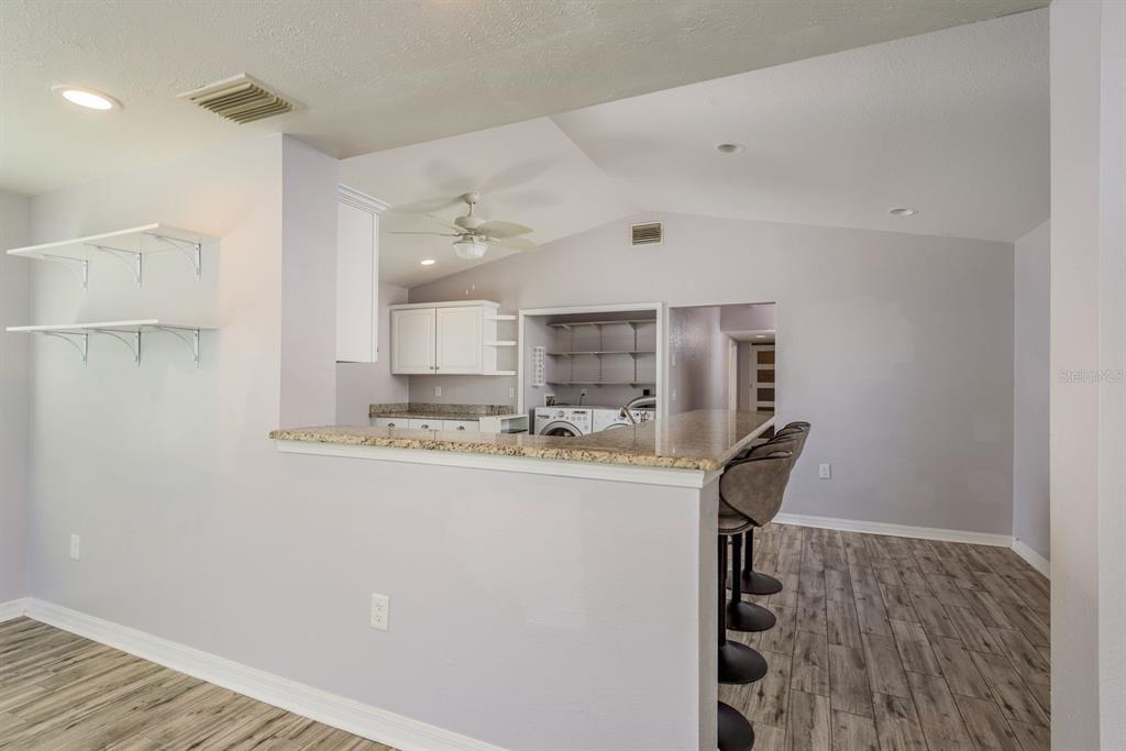 819 10th Street Southwest, Unit A Largo, FL 33770 - Photo 14 of 29 a kitchen with stainless steel appliances granite countertop a refrigerator and a stove top oven