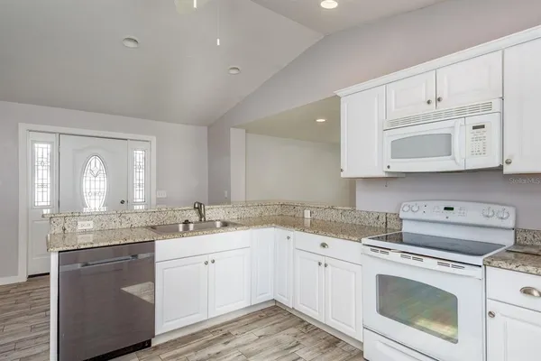 a kitchen with appliances cabinets and a sink