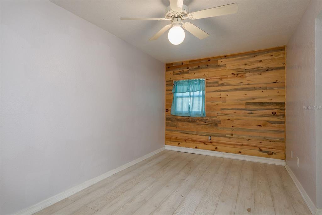 819 10th Street Southwest, Unit A Largo, FL 33770 - Photo 21 of 29 wooden floor in an empty room with a window