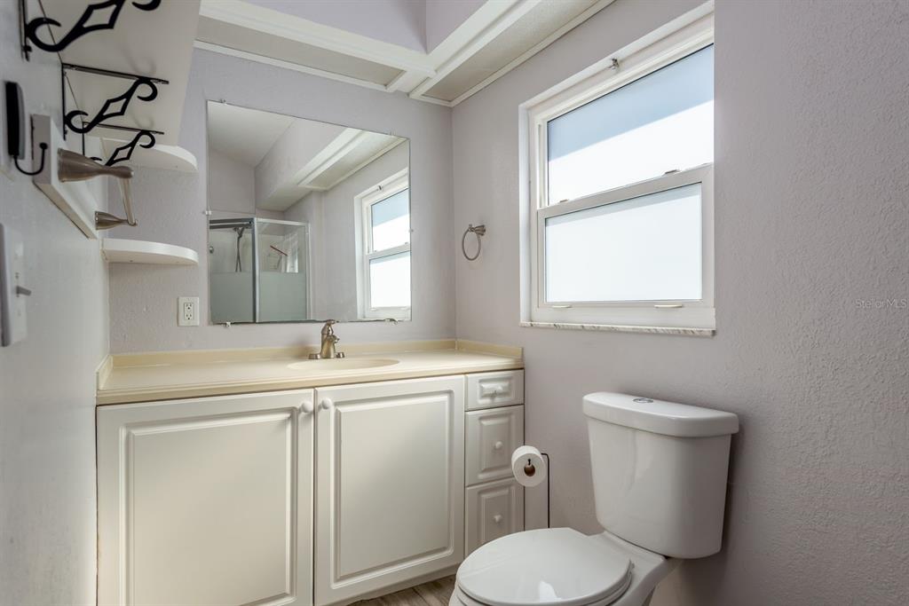 819 10th Street Southwest, Unit A Largo, FL 33770 - Photo 23 of 29 a bathroom with a toilet sink and mirror