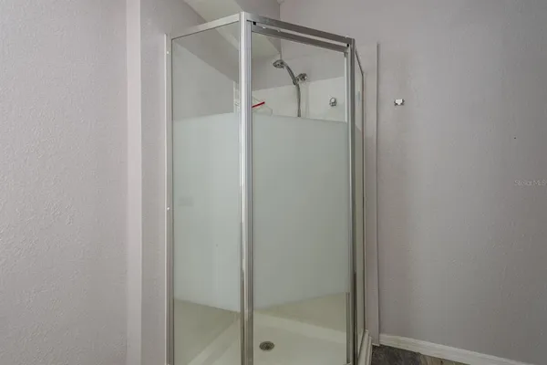 a bathroom with a glass shower door