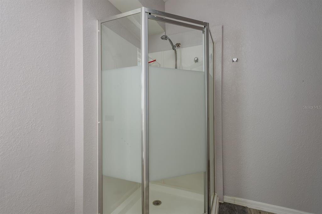 819 10th Street Southwest, Unit A Largo, FL 33770 - Photo 24 of 29 a bathroom with a glass shower door