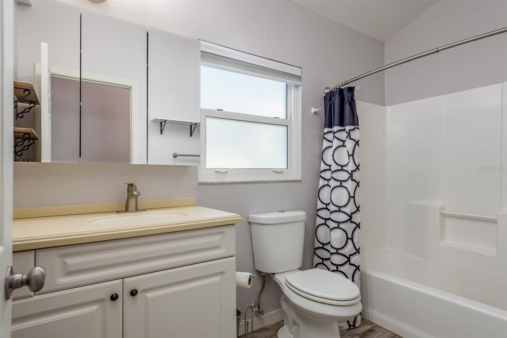 819 10th Street Southwest, Unit A Largo, FL 33770 - Photo 28 of 29 a bathroom with a sink a toilet and a bathtub