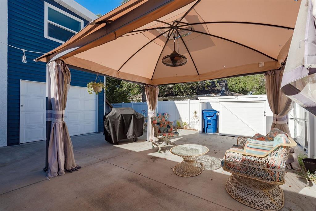 819 10th Street Southwest, Unit A Largo, FL 33770 - Photo 6 of 29 a view of a patio with table and chairs under an umbrella