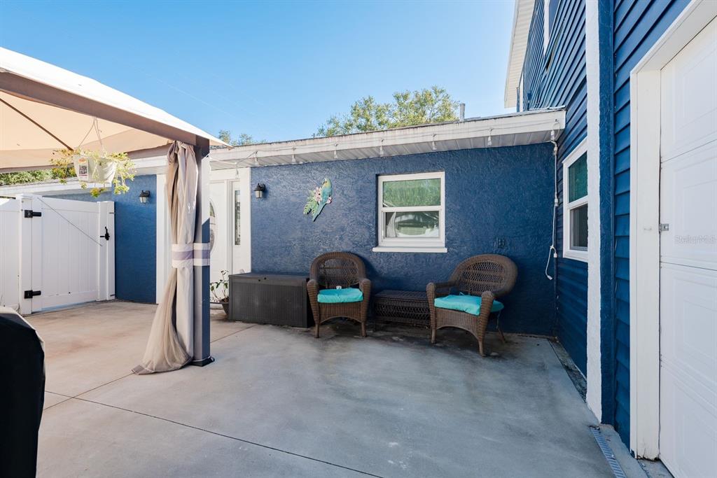 819 10th Street Southwest, Unit A Largo, FL 33770 - Photo 8 of 29 a backyard of a house with barbeque oven table and chairs