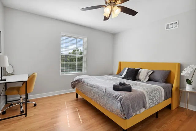 a bedroom with a bed and chair