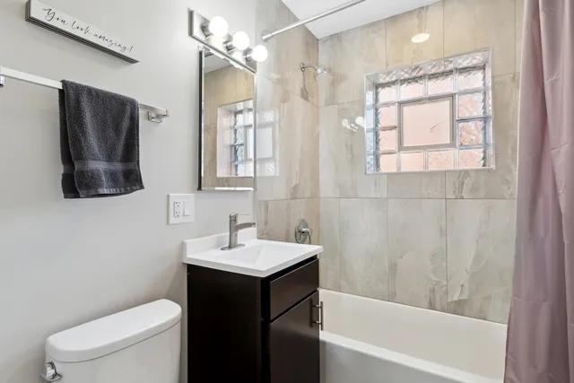 a bathroom with a sink toilet and shower