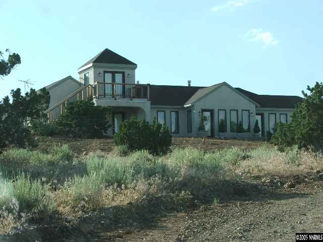 13990 North Red Rock Road Reno, NV 89508 - Photo 1 of 9 a front view of a house with a yard