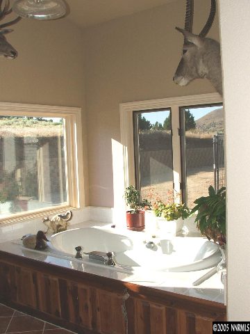 13990 North Red Rock Road Reno, NV 89508 - Photo 8 of 9 a bathroom with a granite countertop sink and a large mirror