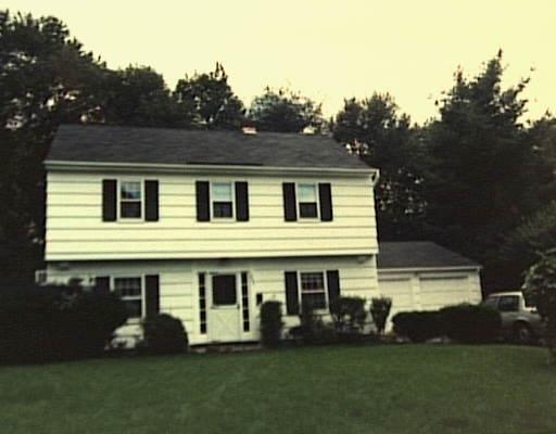 265 Sun Dance Road Stamford, CT 06905 - Photo 1 of 1 a front view of a house with a garden and plants