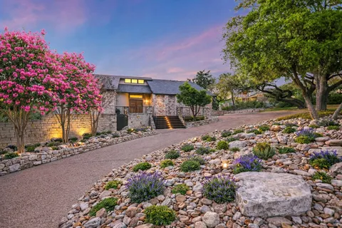 a front view of a house with a yard and fountain
