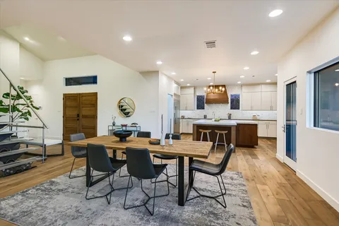 a kitchen with stainless steel appliances granite countertop a sink and a refrigerator
