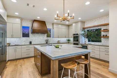 a kitchen with a refrigerator and a potted plant