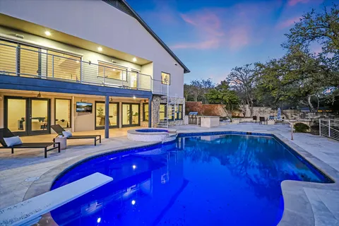 a view of a patio with couches table and chairs and potted plants
