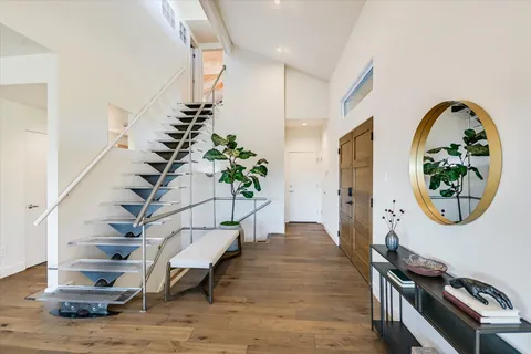 a living room with furniture a fireplace and a floor to ceiling window