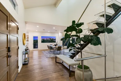 a living room with furniture and a floor to ceiling window