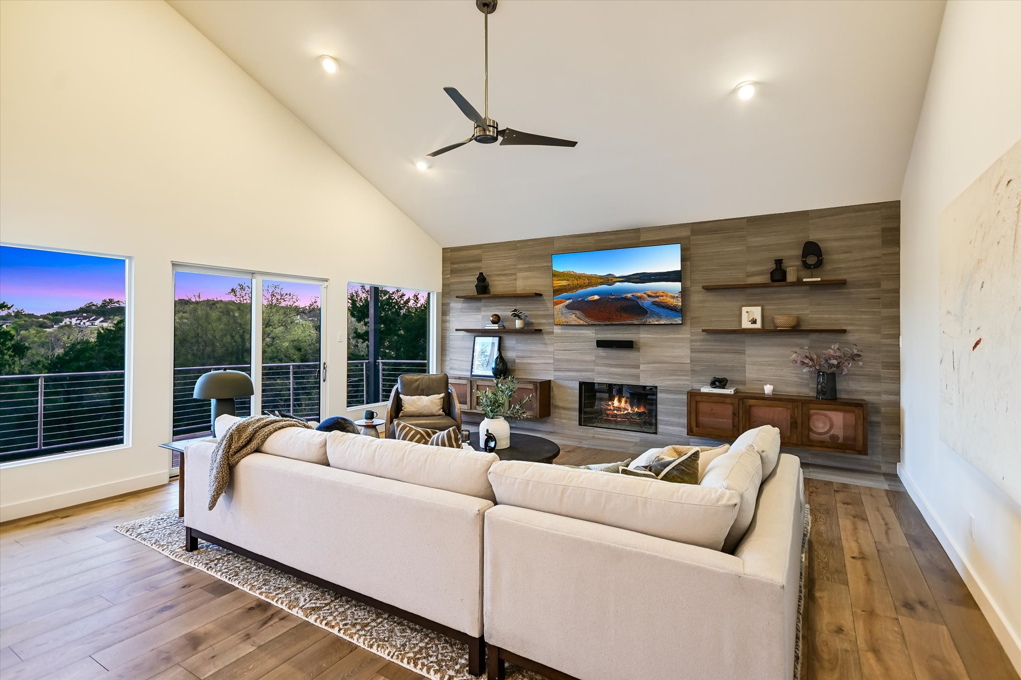 14 Rob Roy Road Austin, TX 78746 - Photo 9 of 40 a living room with furniture a fireplace and a floor to ceiling window