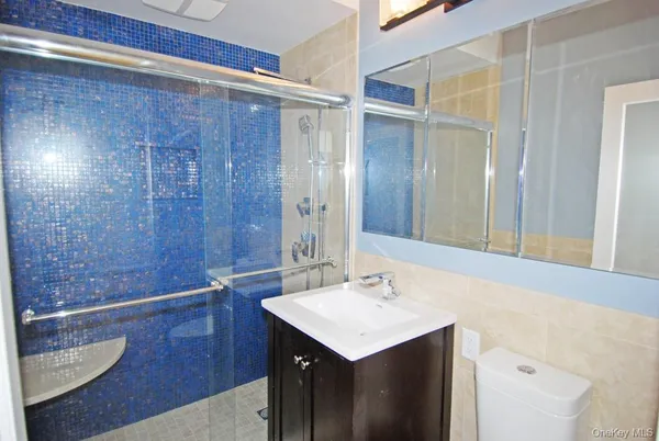 a bathroom with a sink a shower and a mirror