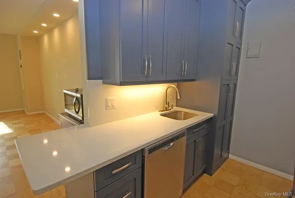 a kitchen with a sink cabinets and wooden floor