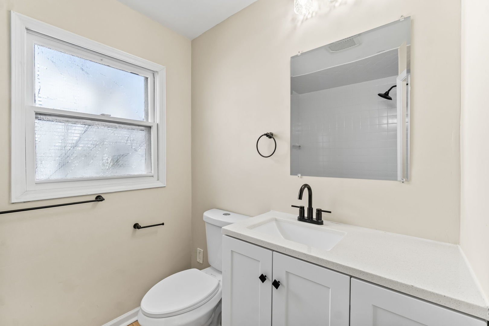 7730 Virginia Court Willowbrook, IL 60527 - Photo 13 of 23 a bathroom with a toilet a sink a mirror and vanity