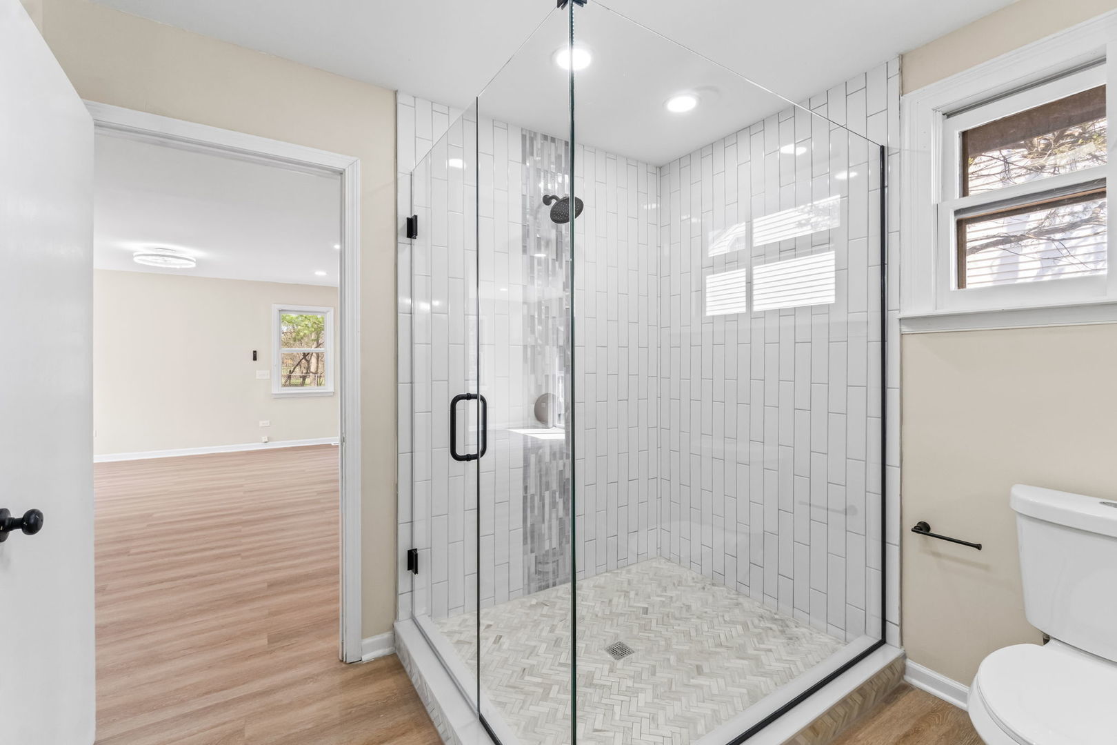 7730 Virginia Court Willowbrook, IL 60527 - Photo 17 of 23 a bathroom with a shower a toilet and sink