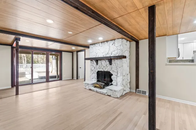 a view of room with wooden floor and fireplace