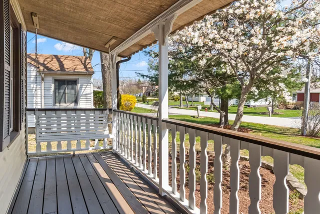a view of a porch with wooden floor and outdoor seating