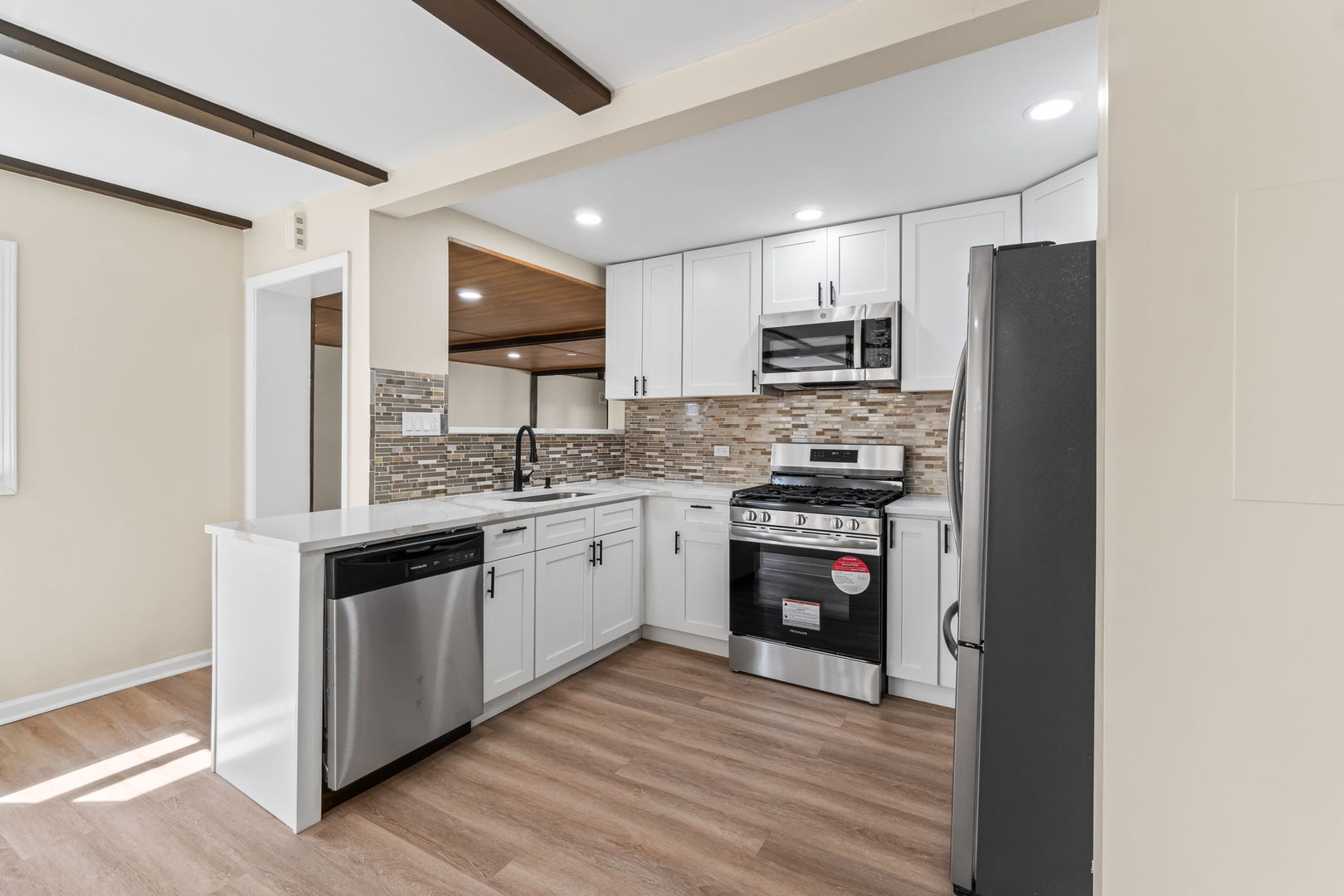 7730 Virginia Court Willowbrook, IL 60527 - Photo 8 of 23 a kitchen with stainless steel appliances granite countertop a stove and a refrigerator