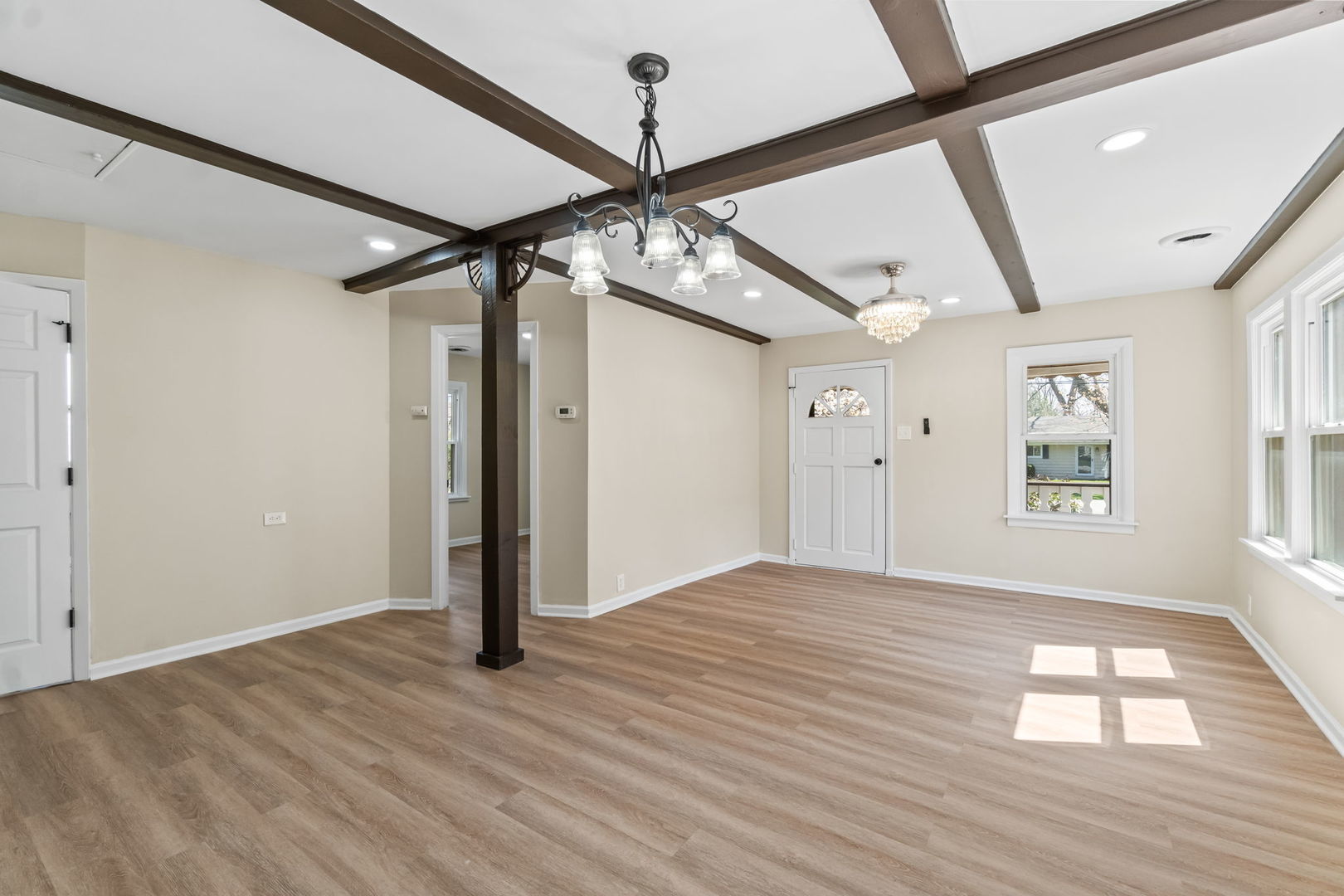 7730 Virginia Court Willowbrook, IL 60527 - Photo 9 of 23 a view of an empty room with wooden floor and a window