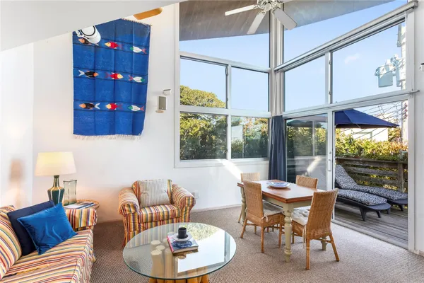 a living room with furniture a rug and a chandelier
