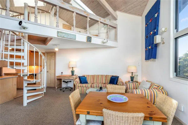 a living room with furniture a rug and a table