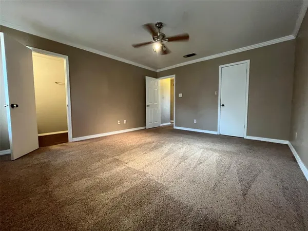 a view of a livingroom with a ceiling fan and window