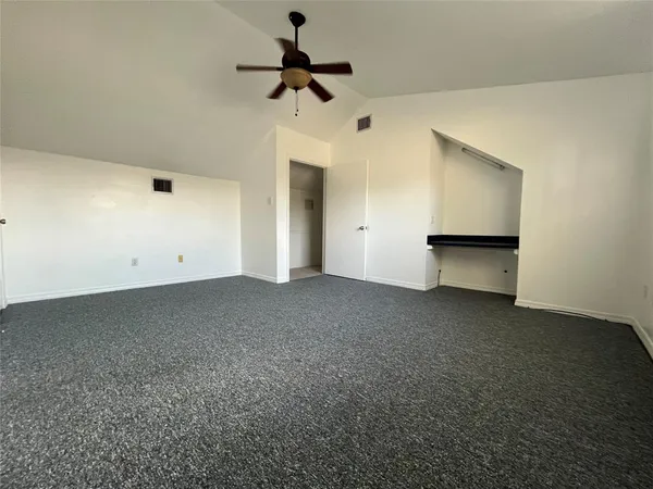a spacious bathroom with a double vanity sink a toilet a mirror and shower