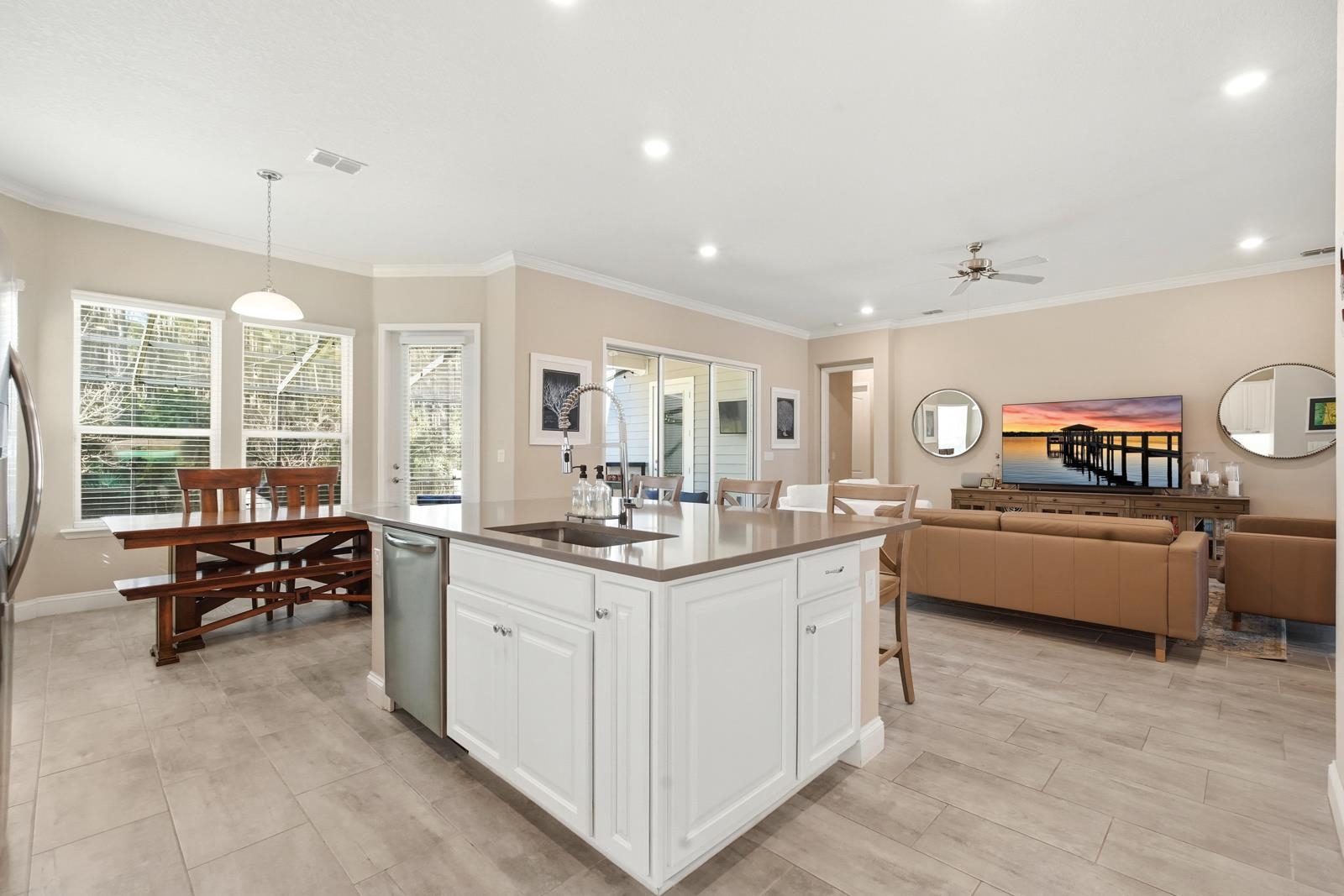 170 Antolin Way St. Augustine, FL 32095 - Photo 85 of 85 Kitchen with white cabinetry, decorative light fixtures, ornamental molding, a kitchen island with sink, and open floor plan