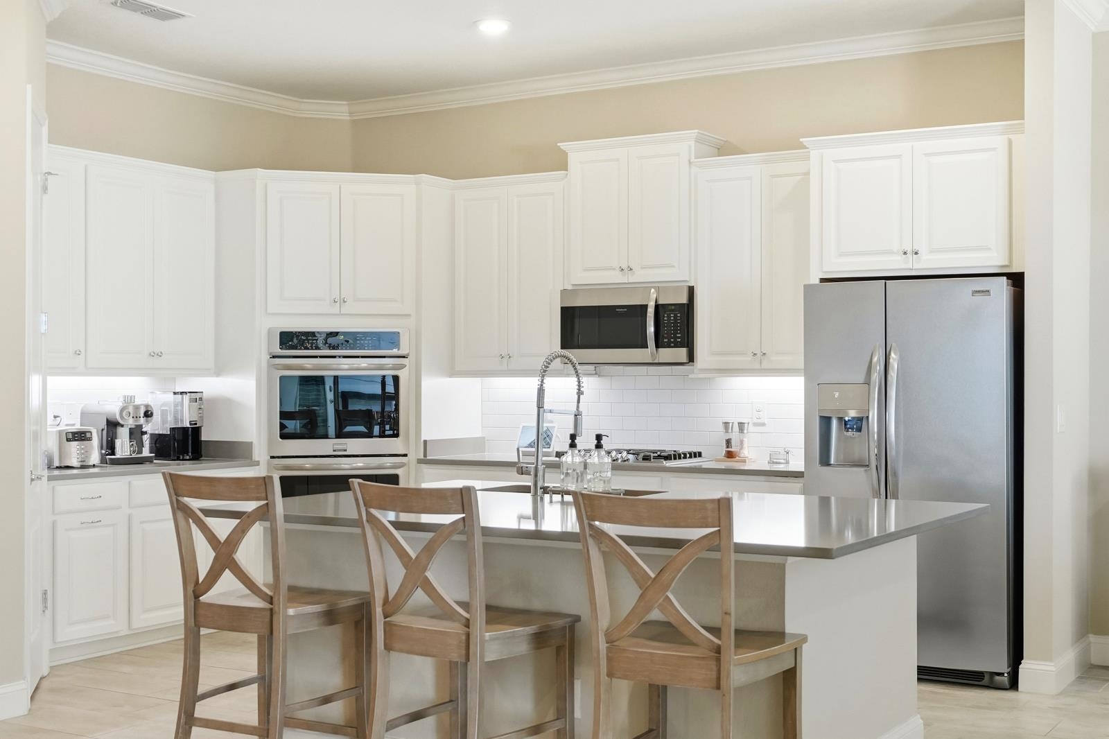 170 Antolin Way St. Augustine, FL 32095 - Photo 24 of 85 a kitchen with stainless steel appliances a table chairs microwave and refrigerator