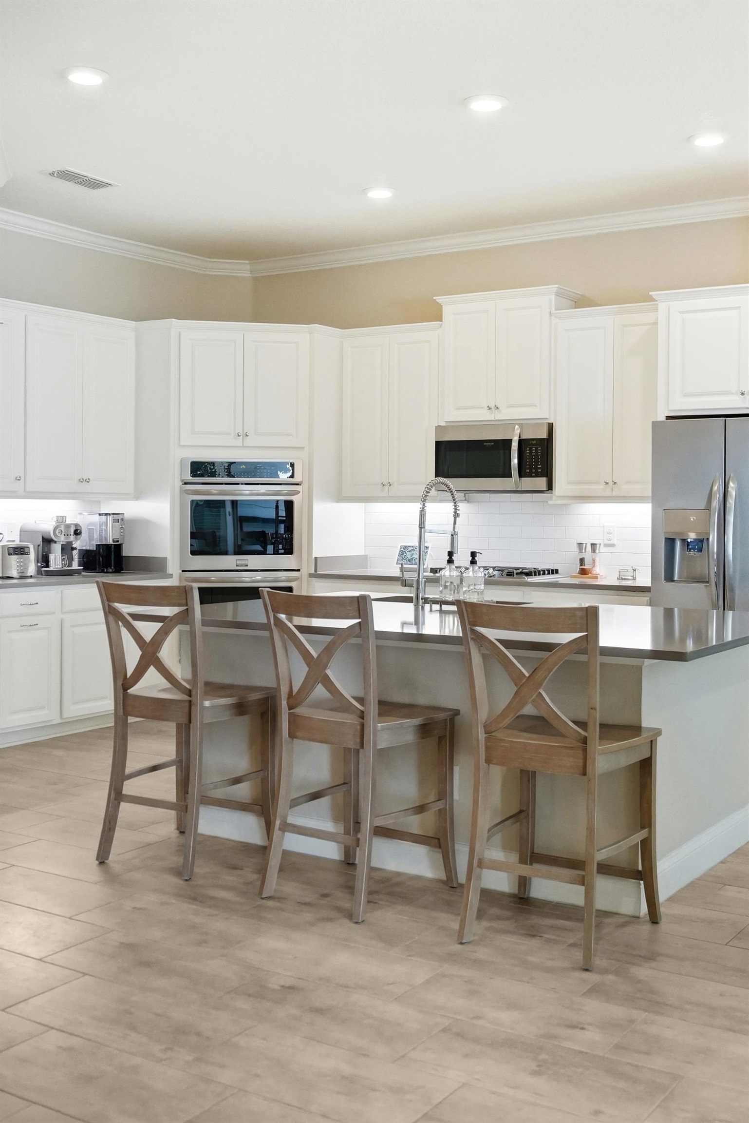 170 Antolin Way St. Augustine, FL 32095 - Photo 25 of 85 a kitchen with kitchen island granite countertop a table chairs microwave and cabinets