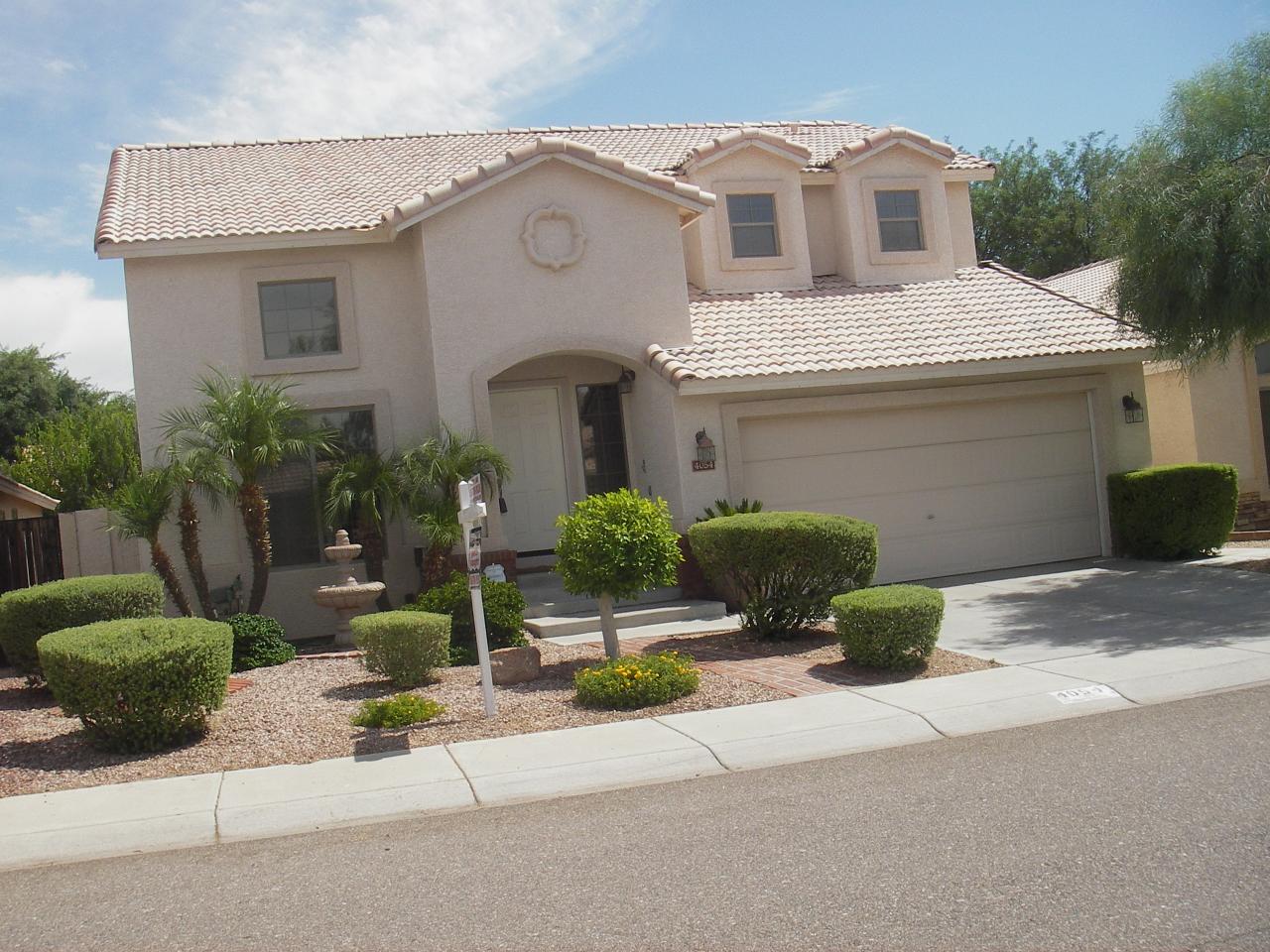 4054 East Agave Road Phoenix, AZ 85044 - Photo 1 of 7 a front view of a house with yard and garage