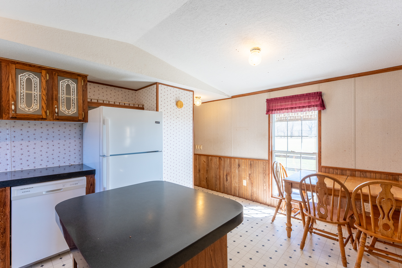 24555 Legion Road Stonefort, IL 62987 - Photo 16 of 41 a kitchen with stainless steel appliances granite countertop a table chairs and a refrigerator