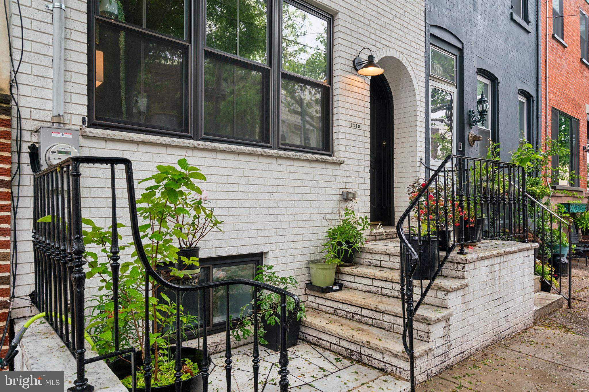 a view of a house with sitting area and potted plants