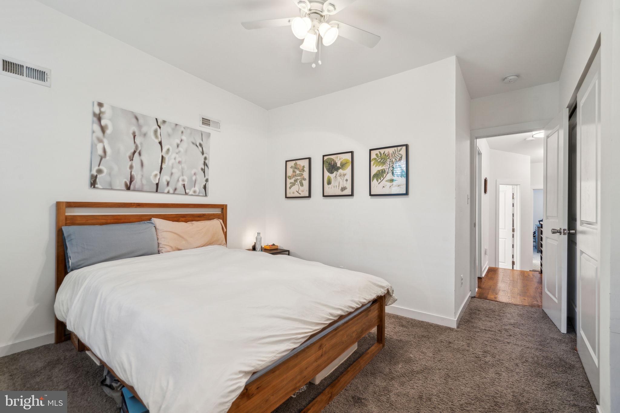 1319 Tasker Street Philadelphia, PA 19148 - Photo 13 of 23 a bedroom with a large bed and a chandelier