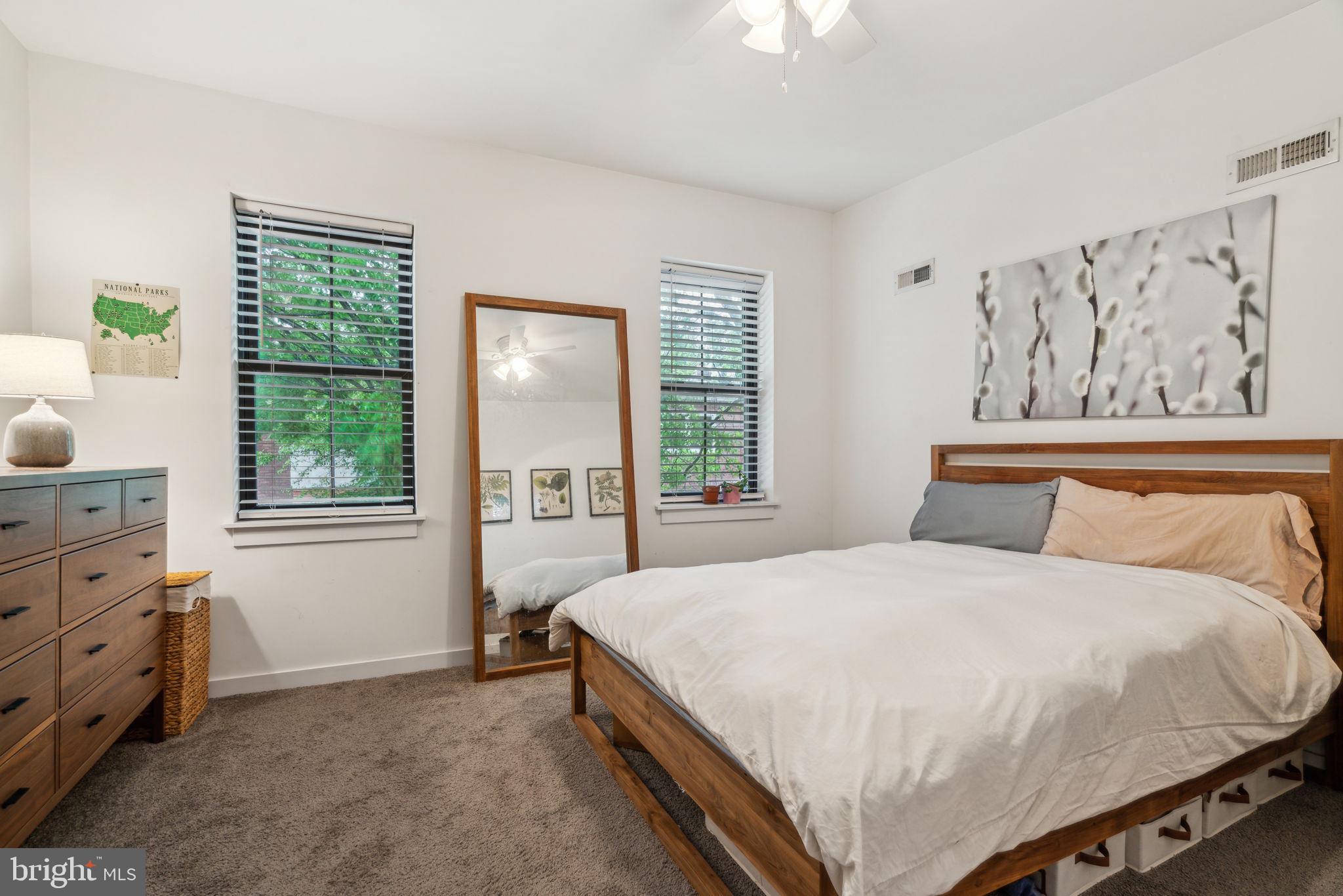 1319 Tasker Street Philadelphia, PA 19148 - Photo 14 of 23 a large bed sitting in a bedroom next to a window